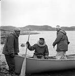 [Mackenzie Porter (far right) and two men getting ready to go canoeing] [between 1956-1960]