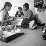 [Sam (middle) and two girls playing with toys, Kinngait, Nunavut] [between 1956-1960]
