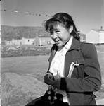 [Girl [Ann Mikidyuk Hansen] smiling outside, Niaqunngut, Iqaluit, Nunavut] [between 1956-1960]