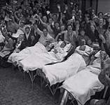 Photograph of hospital patients in their beds in the streets during liberation of Utrecht 1945.