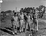 Instructors at RAF school in India stroll near a village, a water buffalo behind. Left to Right are Sergeant Phil Baynes, Corporal Cliff McMillan, F/L Frank MacDonald 6 March 1944.