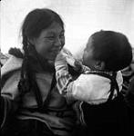 [Kenojuak Ashevak with a baby [Adamie Ashevak], Kinngait, Nunavut] [between 1956-1960]