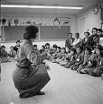 [Group of Brownies listening to their group leader, Iqaluit, Nunavut] 1960