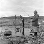 [Mackenzie Porter (right) and a group of people fishing in a small creek, Iqaluit, Nunavut] 1960