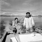 [Barbara Hinds steering a boat with Pitseolak, Iqaluit, Nunavut] 1960