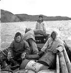 [Mosha Michael (left), Sarpinak (right), Mosesee and Pitseolak on a whale boat, Iqaluit, Nunavut] 1960