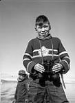[Mosha Michael holding a pair of binoculars, Iqaluit, Nunavut] 1960