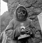 [Mosha Michael holding a camera, Iqaluit, Nunavut] 1960