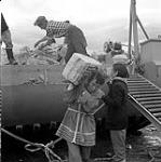 [People unloading bags of sugar from Hudson's Bay Company barge, Niaqunngut, Iqaluit, Nunavut] 1960
