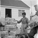 [Two young men stacking bags of sugar, Iqaluit, Nunavut] 1960