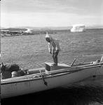 [Sarpinak standing on a whaleboat, Iqaluit, Nunavut] 1960