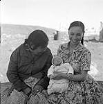 [Two women sitting with a baby, Iqaluit, Nunavut] 1960