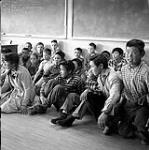 [Children sitting on the ground in a classroom, Iqaluit, Nunavut] 1960
