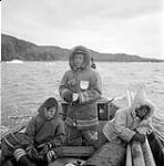 [Mosha Michael (left), Mosesee (center), and Sarpinak (right) travelling on a boat, Iqaluit, Nunavut] 1960