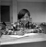 [Boy writing in his notebook, Iqaluit, Nunavut] 1960