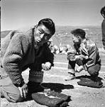 [Men playing games outside, Niaqunngut, Iqaluit, Nunavut] 1960