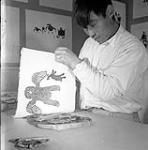[Lukta Qiatsuk making a print, Kinngait, Nunavut] 1960