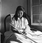 [Young female patient making a beaded belt, Aklavik, Northwest Territories] 1956