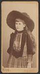 Madge Macbeth as a child, wearing a floppy hat and a plaid dress (3/4 length) ca 1890s.