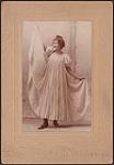 Portrait of Madge Macbeth striking a Loie Fuller inspired dance pose (pose 1) 1895.