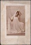 Portrait of Madge Macbeth striking a Loie Fuller inspired dance pose (pose 4) 1895.