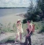 One male and one female hiker on the bank of the Ottawa River in Rockcliffe Park Village, Ontario June 1952