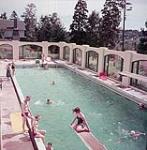 Man and two women in outdoor pool at Digby Pines resort hotel, Digby, Nova Scotia 1952