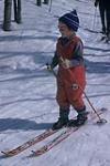 Portrait of young skier, Anthea Naylor, wearing red snow pants and sunglasses. Midget Skiing (probably Camp Fortune) février 1964