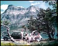 Picnicking in Waterton Lakes National Park, Alta. In background is Vimy Mountain. August 1950.