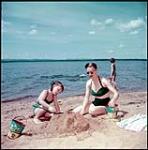 On the sand at Gilwinkee Lodge, tourist resort on Golden Lake, Ont. juillet 1951.