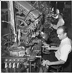 Globe and Mail, workers in the newspaper rooms, Toronto, man operating a typsetting machine [ca. 1939-1951]