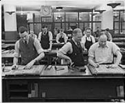 Globe and Mail, workers in the newspaper rooms, men setting type [ca. 1939-1951]