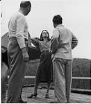 Film "Captains of the Clouds" Cameraman Sal Polite and director Michael Curtis get Brenda Marshall to do a bit of last minute fixing 1941