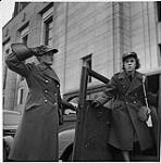 Women's Army, Ottawa. Woman In Uniform Holding the Car Door Saluting a Woman in Uniform December 1941
