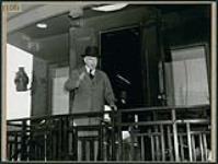 Canada's Prime Minister William Lyon Mackenzie King waves from the observation platform as he leaves to attend the San Francisco Conference May 1945