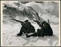 The Lovat Scouts, a Scottish regiment that played a prominent part in the invasion of Europe in WW II learned their mountain tactics and skiing from Canadian instructors high in the Rockies. Two Scout snipers, who usually work in pairs, practise their shooting skills with Mount Andromeda and Mount Athabaska in the background, Jasper 1944