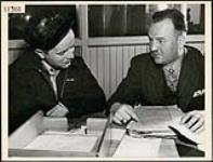 Sgt. James P. Griffiths being interviewed by rehabilitation officer John Raney in Toronto April 1945