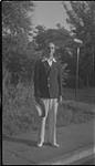 Wilson P. MacDonald standing on a sidewalk [1940]