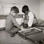 [Sam Houston (left) and Isachee (right) play with blocks] [between 1956-1960]
