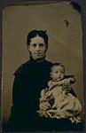Portrait of a woman holding a baby [ca 1875-1910]