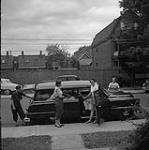 Helen Salkeld, Audrey James, Anna Brown and Rosemary Gilliat (left to right) getting ready to leave Ottawa, Ontario for their Trans-Canada Highway trip July 31, 1954.