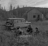 Supper by deserted gold mine buildings, possibly near Geraldton, Ontario August 2, 1954.