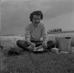 Makeshift bath in Prairies. Audrey James washing up, Portage-la-Prairie, Manitoba. August 5, 1954.