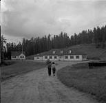 Anna Brown and Audrey James walking towards Whiteshell Fish Hatchery, Manitoba August 4, 1954.
