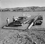 Anna Brown and ferry operator Mr. Weekes on Lancer Ferry, South Saskatchewan River 10 août 1954.