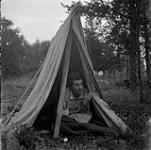 Audrey James in a tent [possibly near Temagami, Ontario, July 31, 1954] [31 juillet 1954].