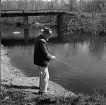 Heinrich Fast fishing in Rat River near Steinbach, Manitoba June 1, 1956.