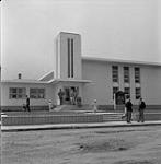 People leaving the Evangelical Mennonite Brethren Church, Steinbach, Manitoba June 1, 1956.
