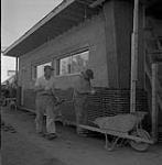 Bricklayers working in Steinbach, Manitoba June, 1956.