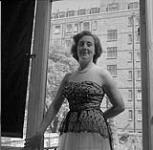 Close-up of Woman in Nice Dress in Doorway, H.B.C. Trail, British Columbia July 1, 1955